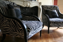 Armchairs covered in a zebra-print fabric